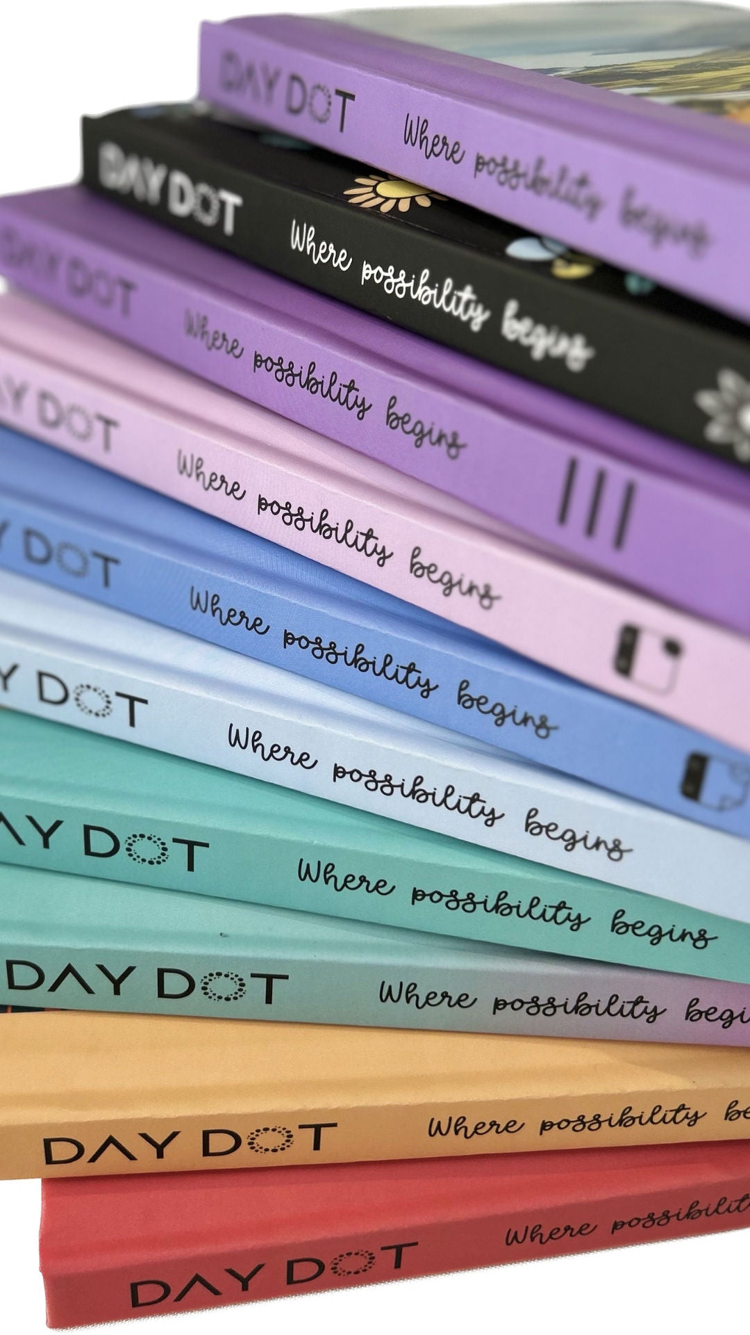 Stack of DayDot journals with various cover designs